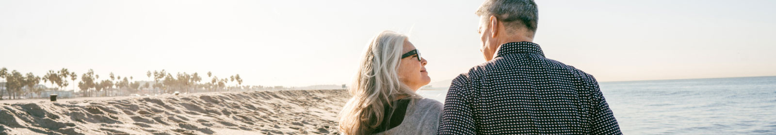 mature couple walking down the beach