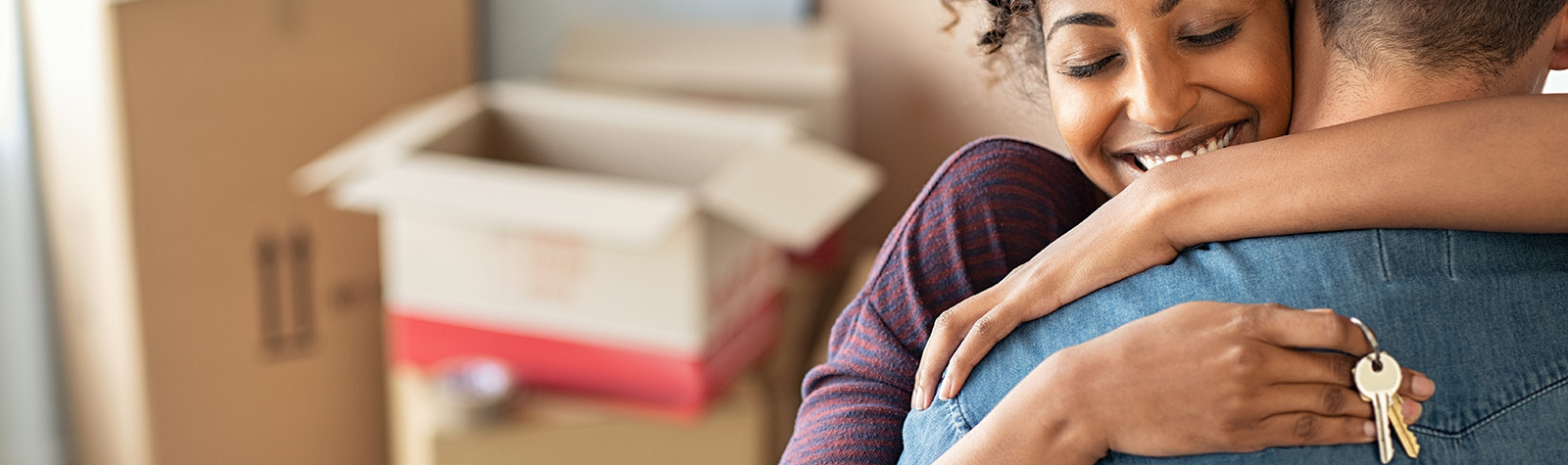 Happy couple hugging with new home keys