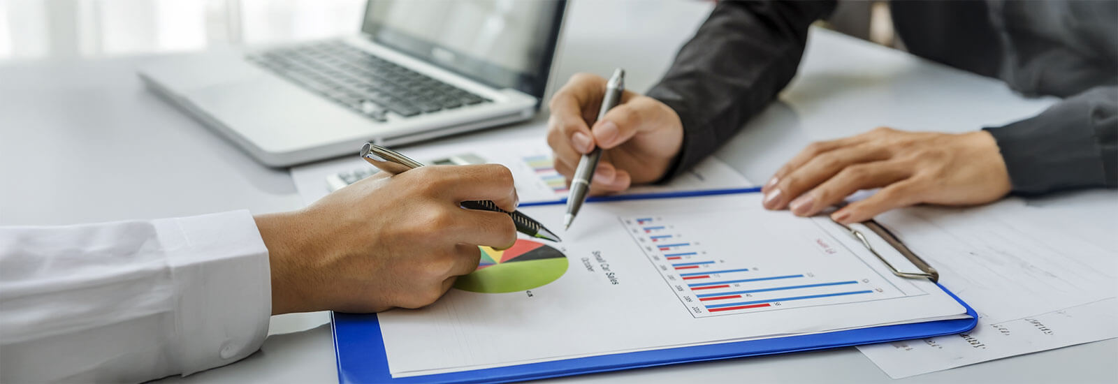 Business meeting with charts and laptop