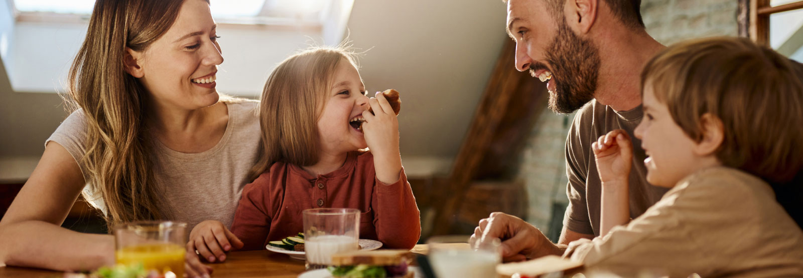 young family eating breakfast around a table